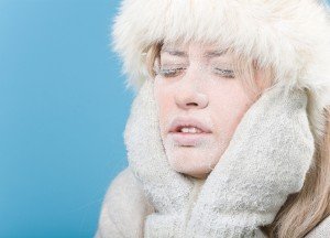 Frozen. Chilled female face covered in snow ice